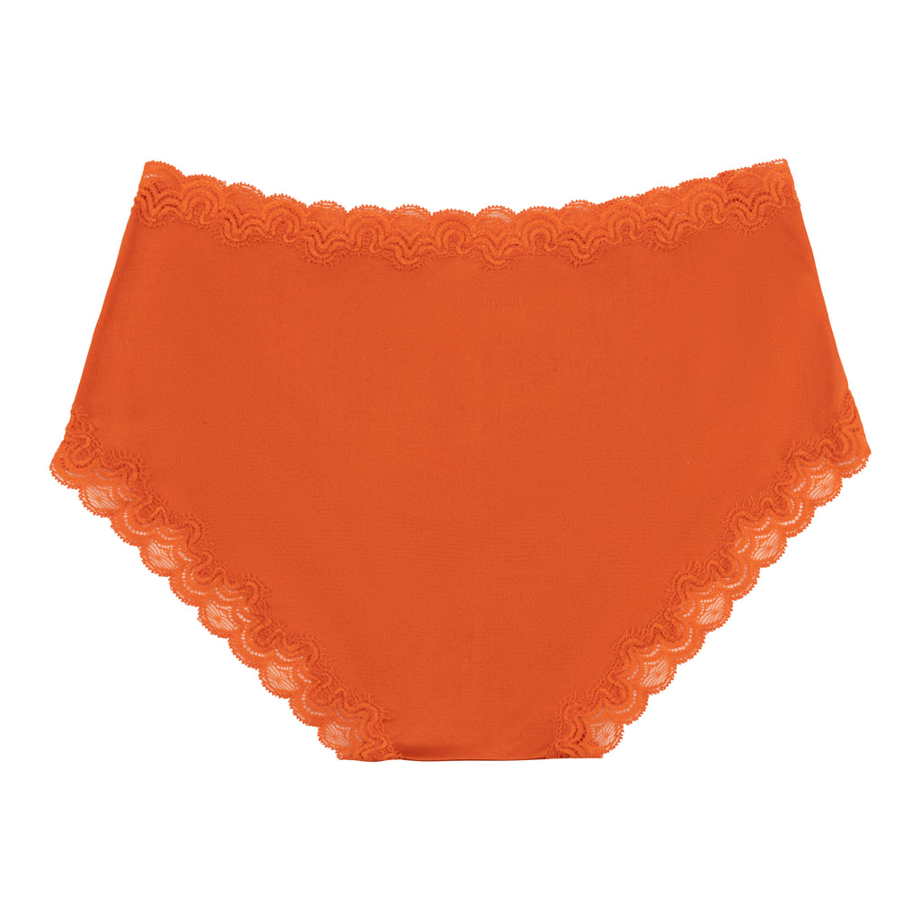 Still life of Uwila Warrior Soft Silks Briefs Underwear in Spicy Orange on White Background