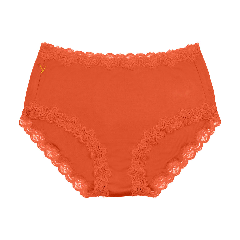 Still life of Uwila Warrior Soft Silks Briefs Underwear in Spicy Orange on White Background